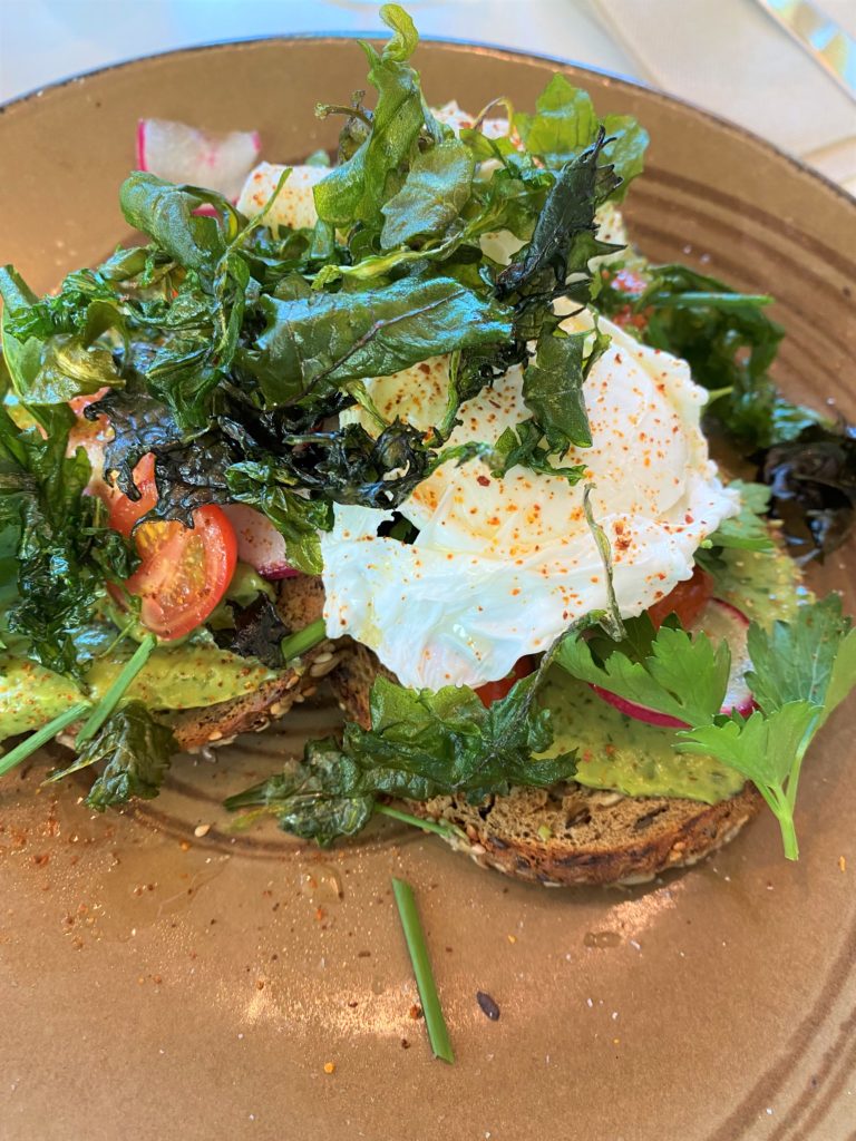avocado toast with poached egg and greens